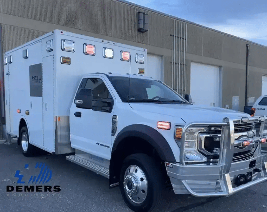 Demers Type I ambulance on a Ford chassis with a modular patient compartment and emergency lighting.