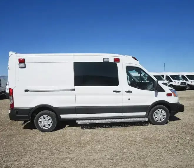 Demers Type II Transit TSE ambulance with a van-based body, emergency lighting, side access doors, and exterior equipment storage.