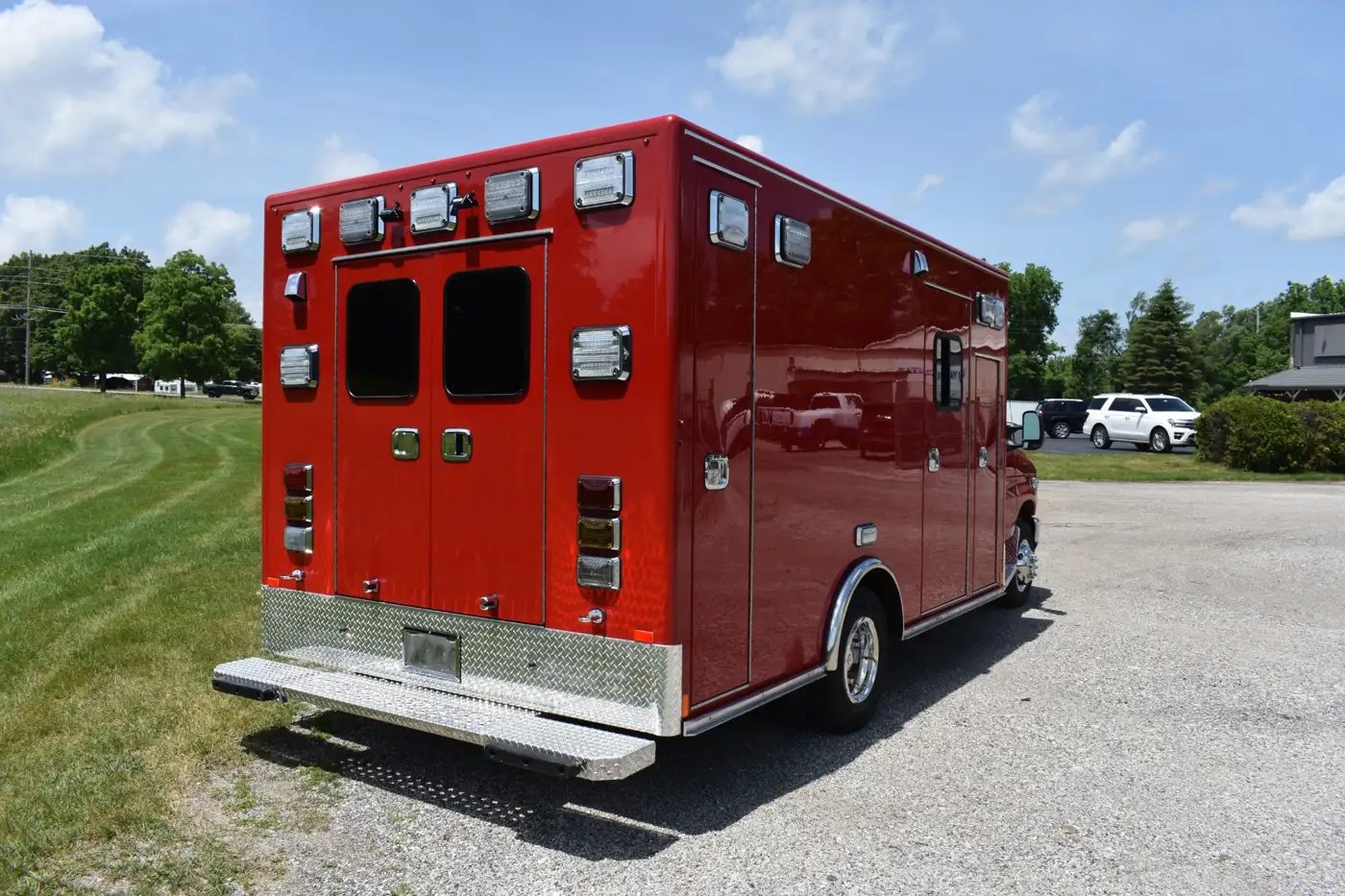 Rear-right exterior view of a Type III remount ambulance, showcasing the modular patient compartment, rear access area, emergency lighting, and exterior storage features.