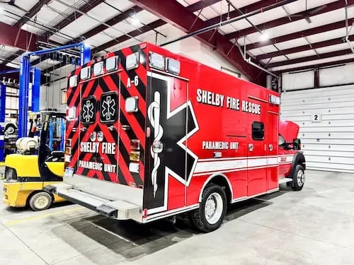 Completed ambulance remount showing refurbished patient module and updated chassis for Shelby Fire Rescue.