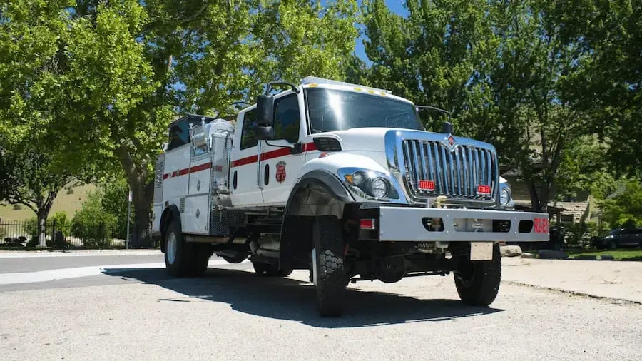 BME Type 4 Aspen fire engine with a crew cab, side equipment compartments, off-road tires, and a utility-style fire body.
