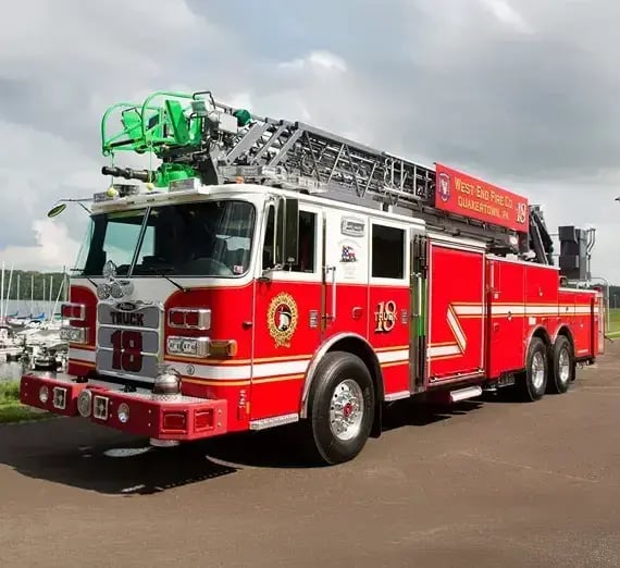 Pierce aerial ladder apparatus equipped with an extended aerial ladder, emergency response lighting, and firefighting systems for rescue, suppression, and elevated access operations.