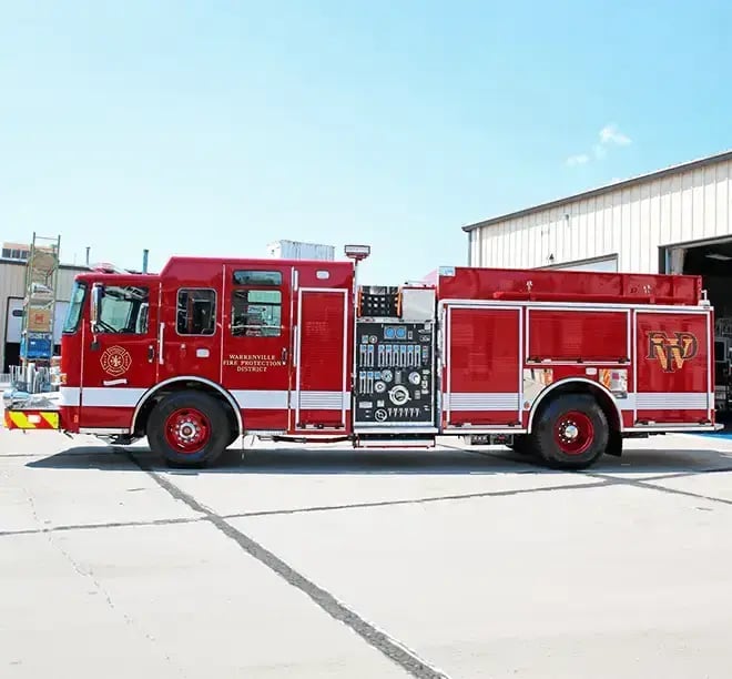 Pierce pumper fire truck equipped with a water pump, hose storage compartments, and firefighting equipment.