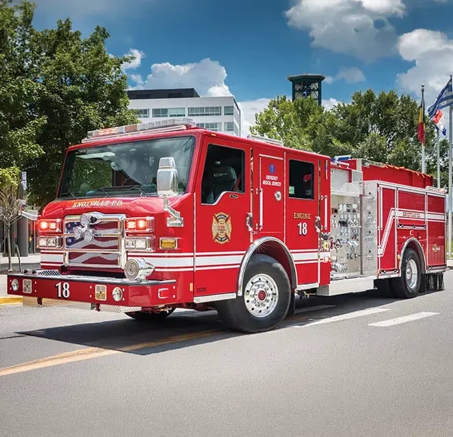 Pierce Velocity fire apparatus built on a custom chassis with a crew cab, equipment compartments, and emergency warning lights.