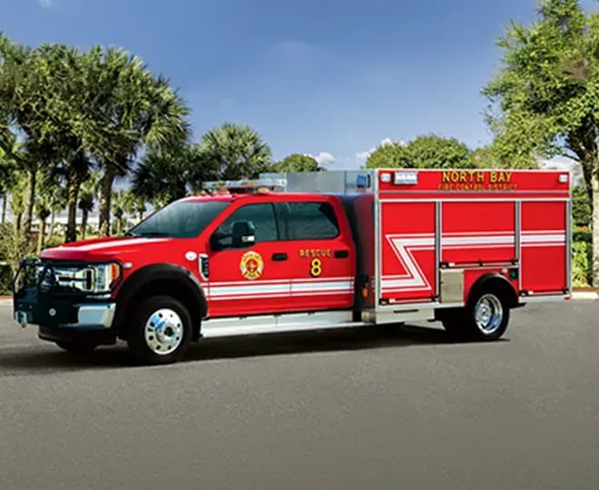 Pierce mini pumper fire apparatus with a compact body, pump system, equipment compartments, and emergency warning lights.