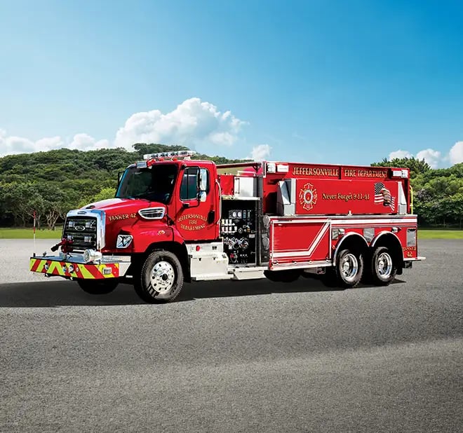 Pierce elliptical tanker shown from the dry side with a water tank body, equipment compartments, and emergency warning lights.