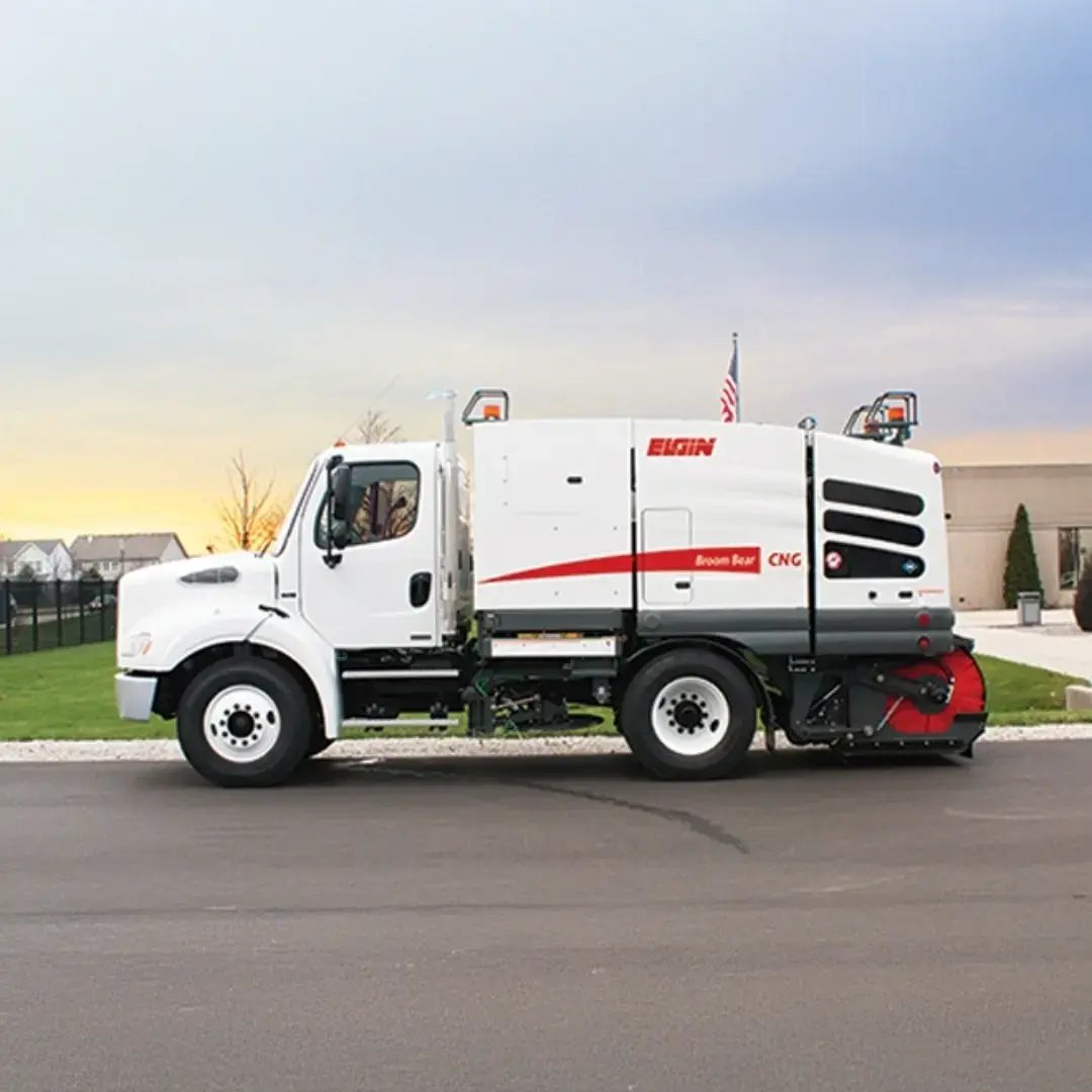 Elgin Broom Bear street sweeper parked outdoors, featuring regenerative air sweeping technology for efficient debris removal on municipal streets and paved surfaces.