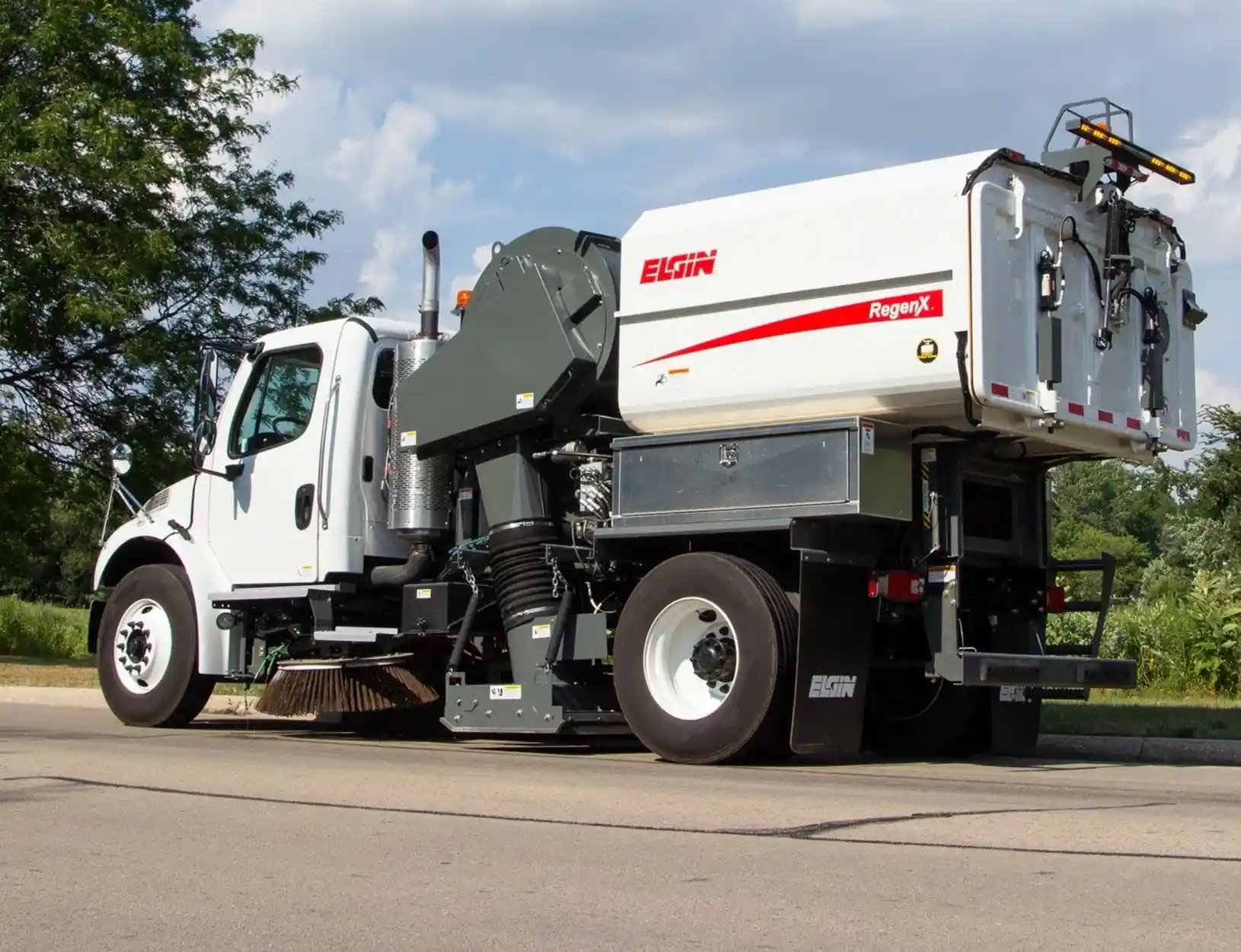 Elgin RegenX air street sweeper parked on a roadway, featuring regenerative air sweeping technology for municipal street cleaning, debris removal, construction site cleanup, and pavement maintenance operations.