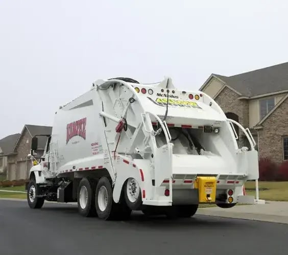 McNeilus tag axle refuse truck on a Freightliner chassis designed for increased payload capacity, commercial waste collection, and reliable fleet performance.