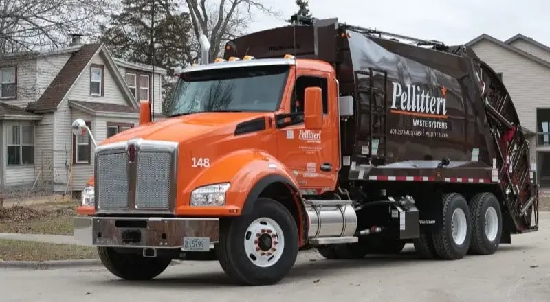 McNeilus rear-loader refuse truck operated by Pellitteri Waste Systems, providing reliable residential and commercial waste collection services.