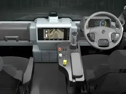 Modern electric refuse truck cab featuring a digital dashboard, touchscreen display, camera monitoring system, and ergonomic driver controls for safe and efficient waste collection operations.