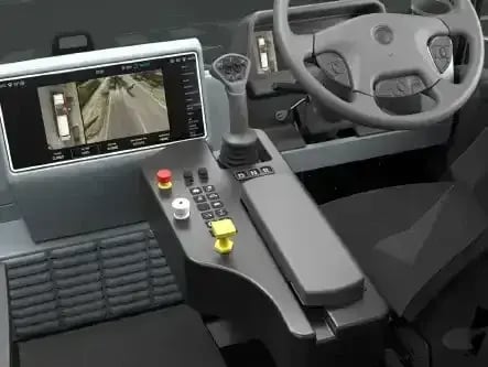 Electric refuse truck operator control panel featuring a touchscreen display, camera monitoring system, ergonomic joystick controls, and advanced safety technology.