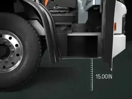 Low-entry electric refuse truck cab featuring a 15-inch step height for improved operator safety, accessibility, and ergonomic vehicle entry.