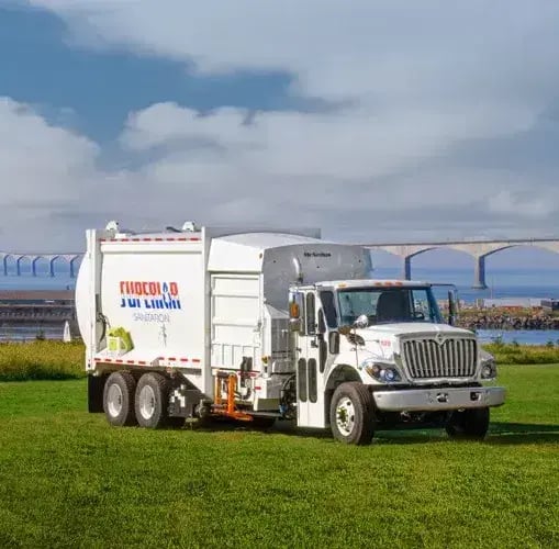 McNeilus Manual Automated Dropframe side loader refuse truck engineered for efficient residential waste collection, ergonomic operation, and reliable curbside pickup performance.