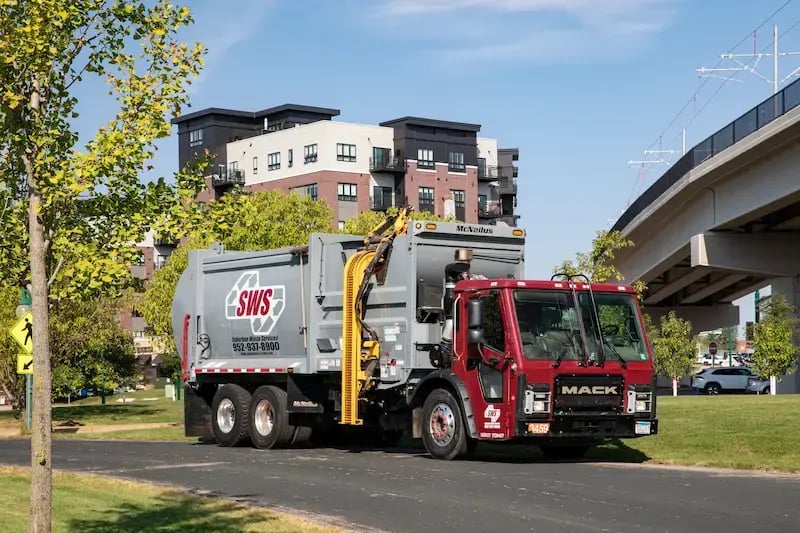 McNeilus ZR automated side loader mounted on a Mack chassis for efficient residential refuse collection.