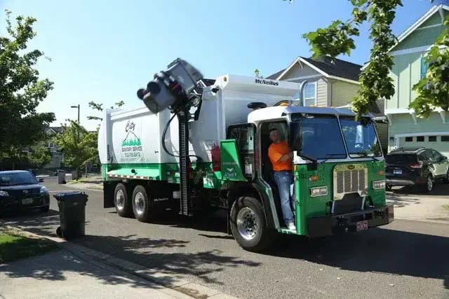 McNeilus ZR automated side loader mounted on a Peterbilt chassis for residential waste collection operations.
