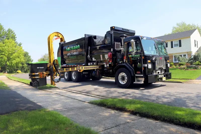 Peterbilt chassis equipped with a McNeilus ZR automated side loader for municipal sanitation fleets.