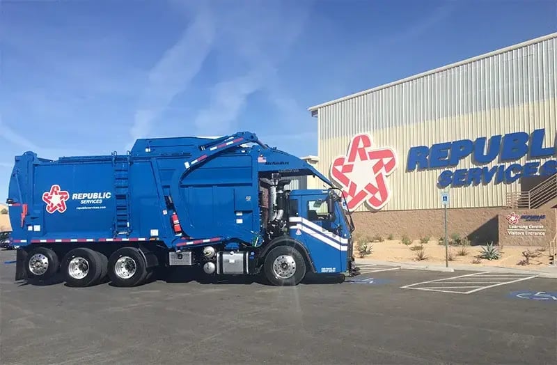 Republic Services automated side loader garbage truck parked outside a company facility, showcasing residential waste collection equipment and modern automated curbside pickup technology.