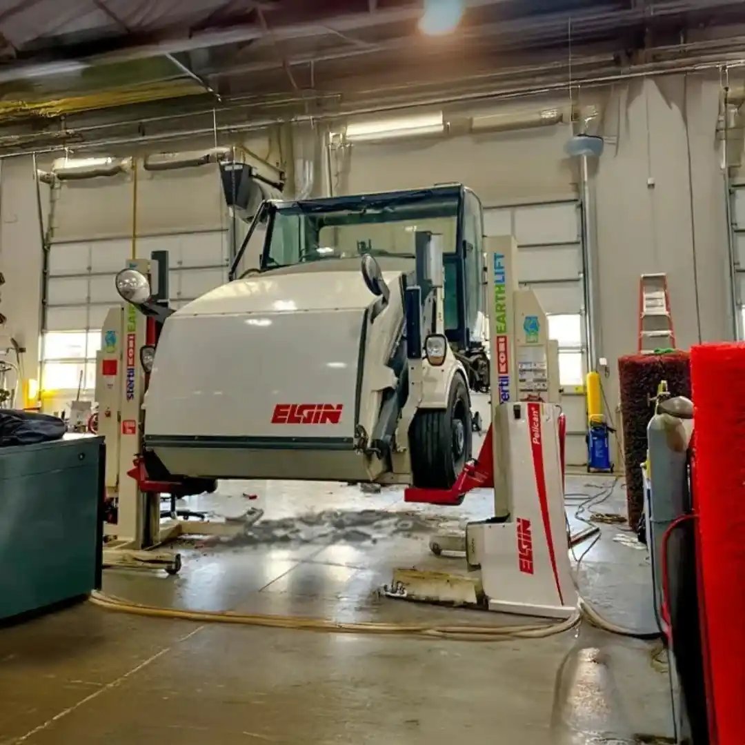 Elgin Pelican street sweeper undergoing preventative maintenance, with access panels open for inspection and servicing to support reliable performance and operational readiness.