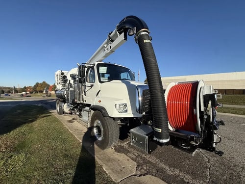 Front driver side angle of a MacQueen stock 2027 Vactor 2100i