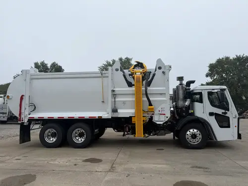 Side image of in stock 2027 McNeilus ZR showing side loader arm