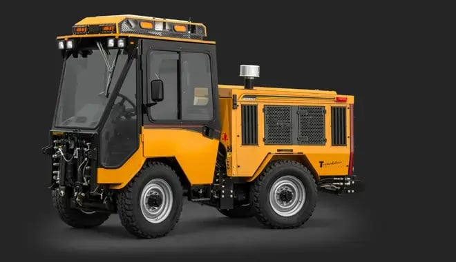 Trackless MT7 municipal multi-purpose tractor with enclosed operator cab, front attachment mount, and all-wheel drive for year-round maintenance and snow removal.