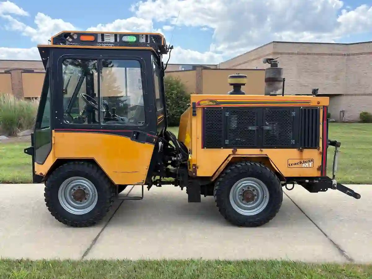 Trackless MT7 municipal utility vehicle highlighting its compact design, operator cab, and attachment-ready configuration.