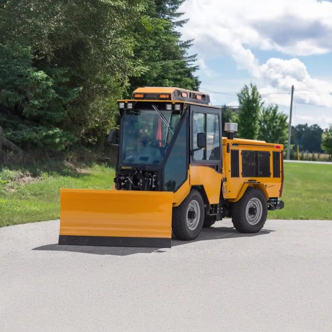 Trackless MT7 municipal tractor equipped with a front snowplow blade, designed for year-round municipal maintenance and winter snow removal.