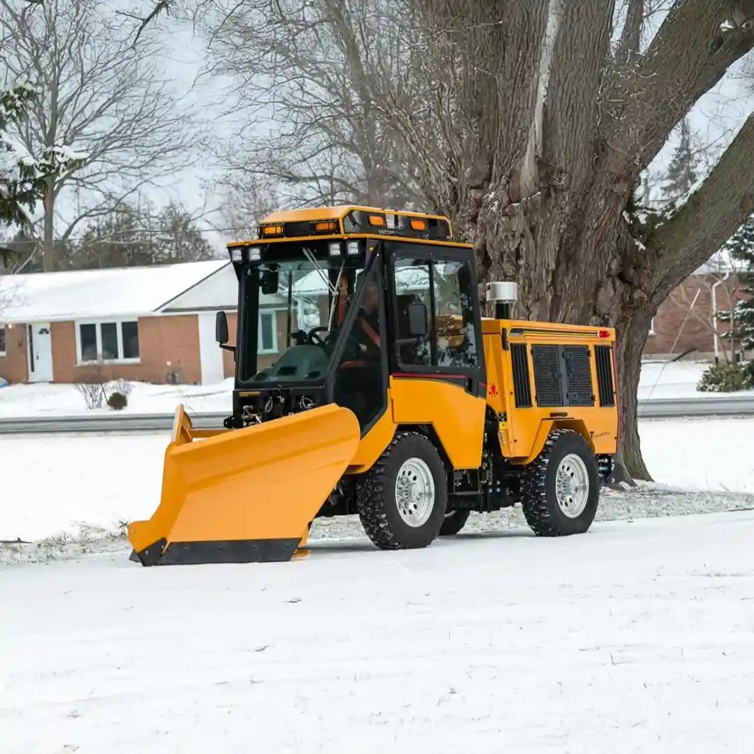 Trackless MT7 municipal tractor equipped with a front V-plow for clearing snow from roads, sidewalks, parking lots, and other public spaces.