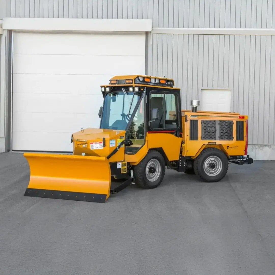 Trackless MT7 municipal tractor equipped with a front snowplow for efficient snow removal and year-round municipal maintenance.