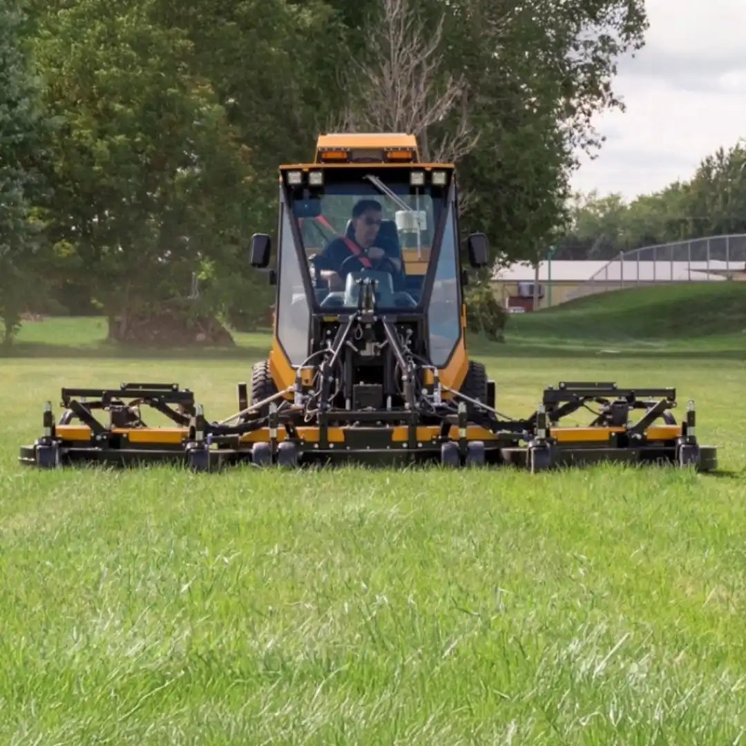 Trackless MT7 municipal tractor equipped with a front-mounted wide-area mower for maintaining parks, athletic fields, campuses, and large green spaces.