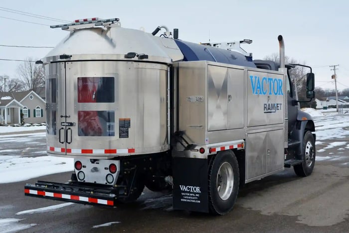 Vactor Ramjet truck operating on a public street, showcasing its high-pressure water jetting system used for sewer cleaning and pipeline maintenance.