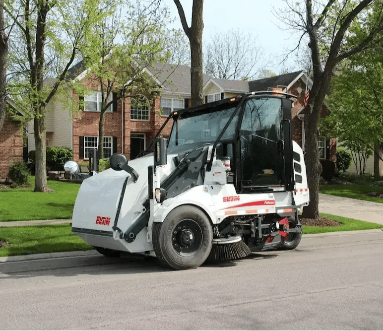 Elgin Pelican mechanical street sweeper maintaining neighborhood streets to support clean, safe, and well-kept public roadways.