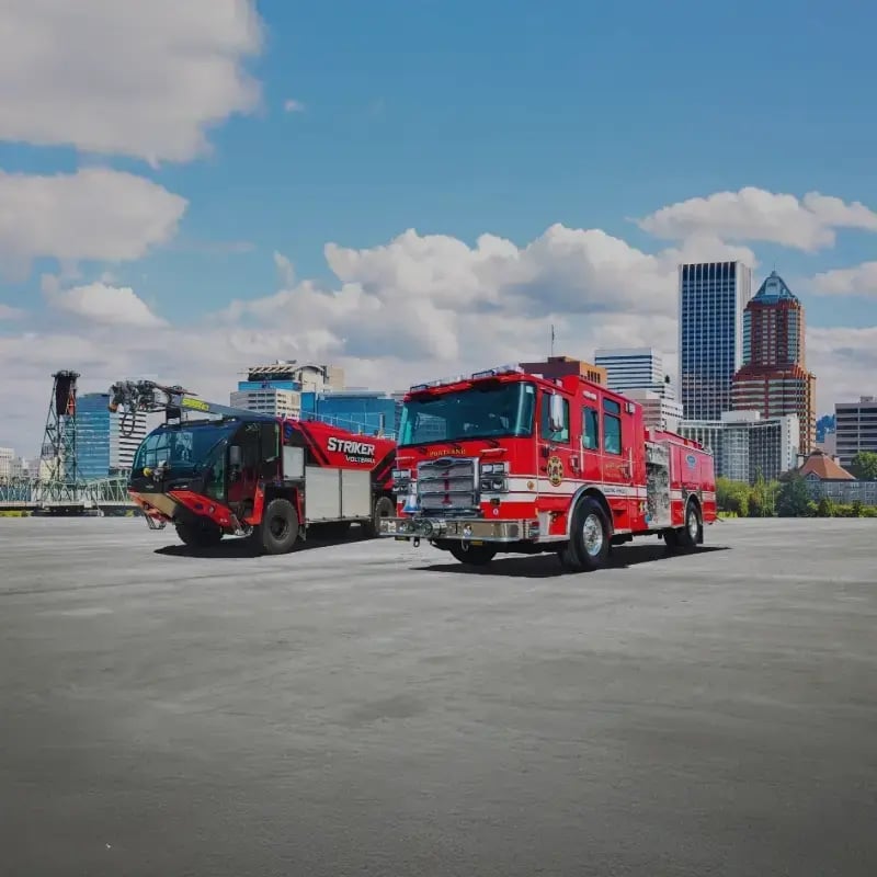 Two Pierce fire apparatus positioned side by side, representing emergency response vehicles and fire protection solutions.