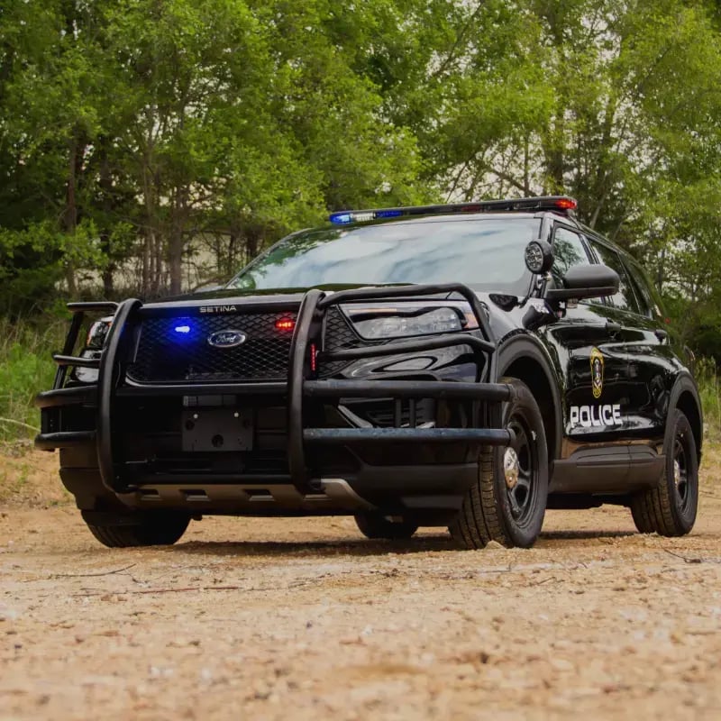 Police SUV equipped with emergency lighting and protective accessories, representing law enforcement vehicle upfitting and public safety equipment installation.