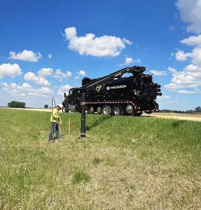 TRUVAC HXX hydro excavation truck performing non-destructive utility locating and daylighting operations in a field environment.