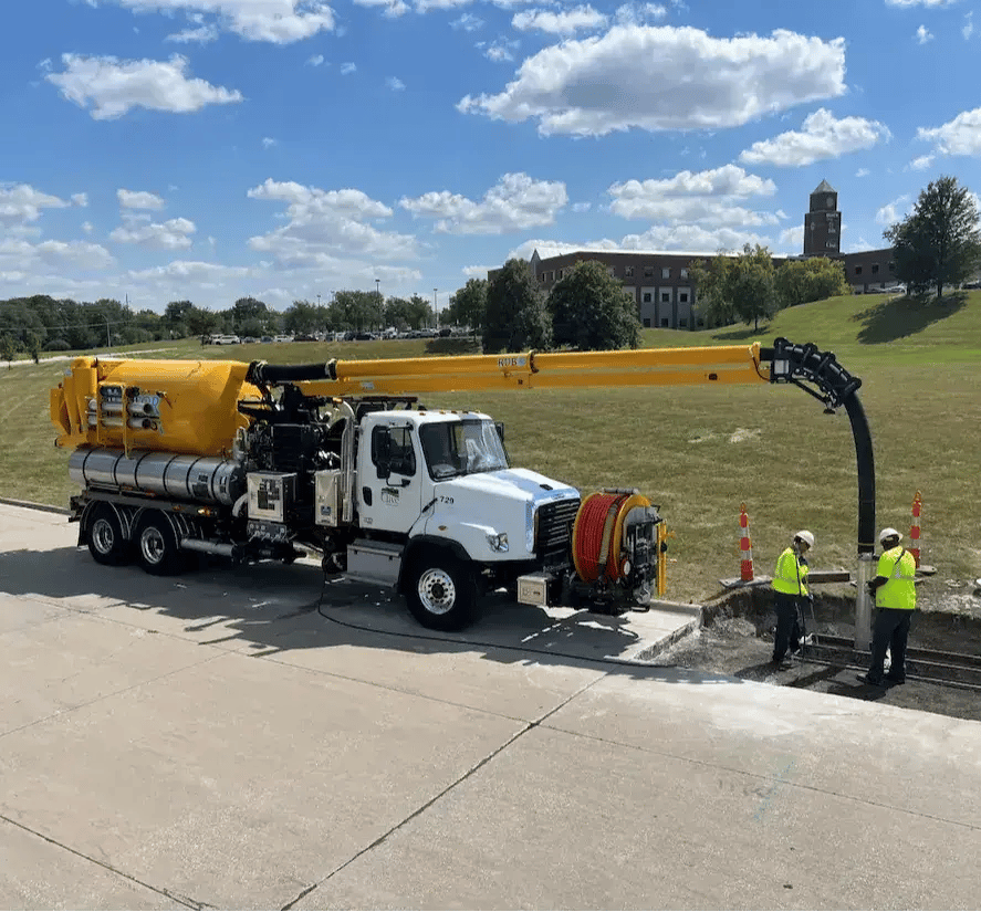 Vactor 2100i combination sewer cleaner performing wastewater system maintenance and underground utility access operations.