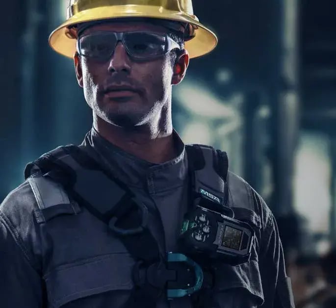 Worker wearing an MSA ALTAIR io4 gas detector for real-time monitoring of hazardous gases in an industrial environment.