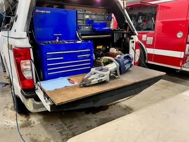 Hurst rescue tool positioned on a mobile service truck workstation with onboard tool storage and maintenance equipment.