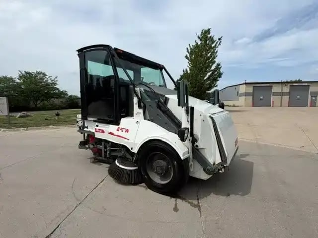 Front passenger-side view of a 2018 Elgin Pelican NP street sweeper.