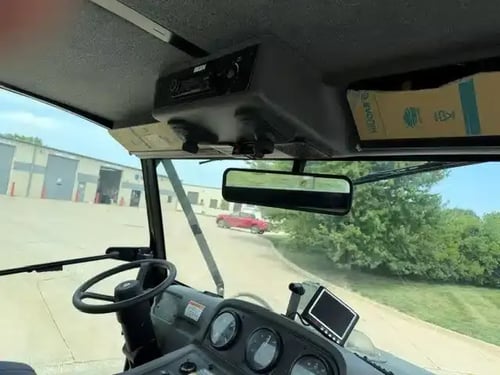 Operator cab and dashboard inside a 2018 Elgin Pelican NP street sweeper.