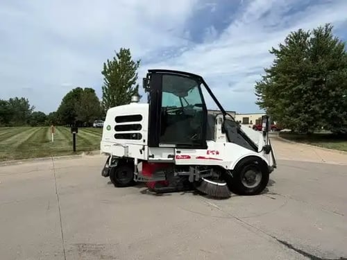Passenger side profile of a 2018 Elgin Pelican NP street sweeper.