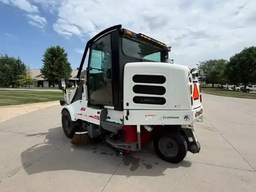 Rear driver-side view of a 2018 Elgin Pelican NP street sweeper.