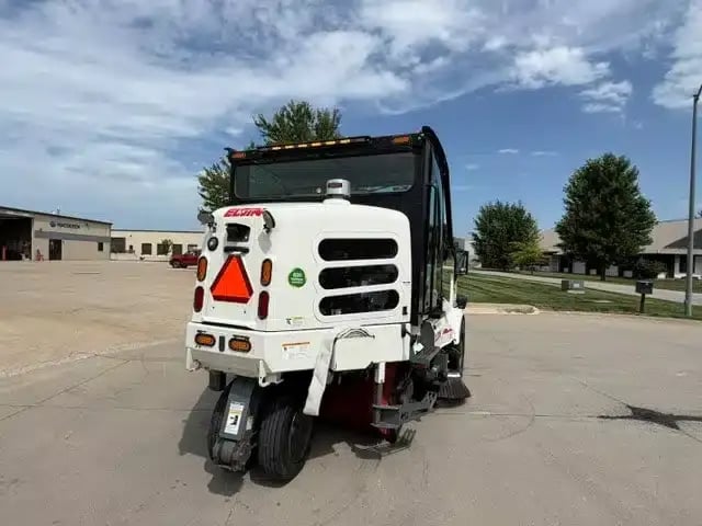 Rear passenger-side view of a 2018 Elgin Pelican NP street sweeper.