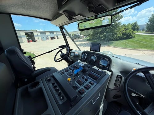 Operator cab and controls inside a 2015 Elgin Pelican NP street sweeper