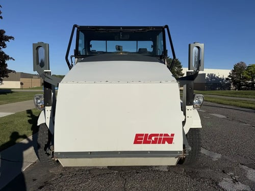 Front view of a 2016 Elgin Pelican NP street sweeper.