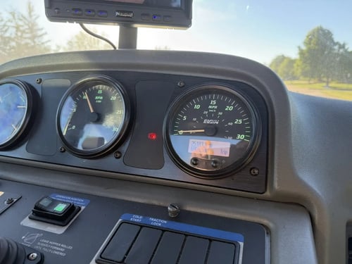 Hour meter and instrument cluster on a 2016 Elgin Pelican NP street sweeper.