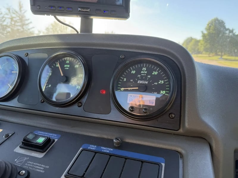 Hour meter and instrument cluster on a 2016 Elgin Pelican NP street sweeper.