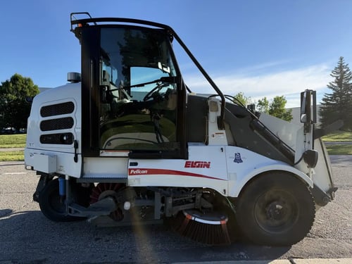 Passenger-side profile of a 2016 Elgin Pelican NP street sweeper.