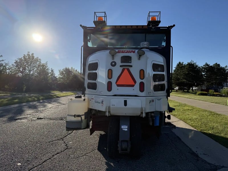 Rear view of a 2016 Elgin Pelican NP street sweeper.